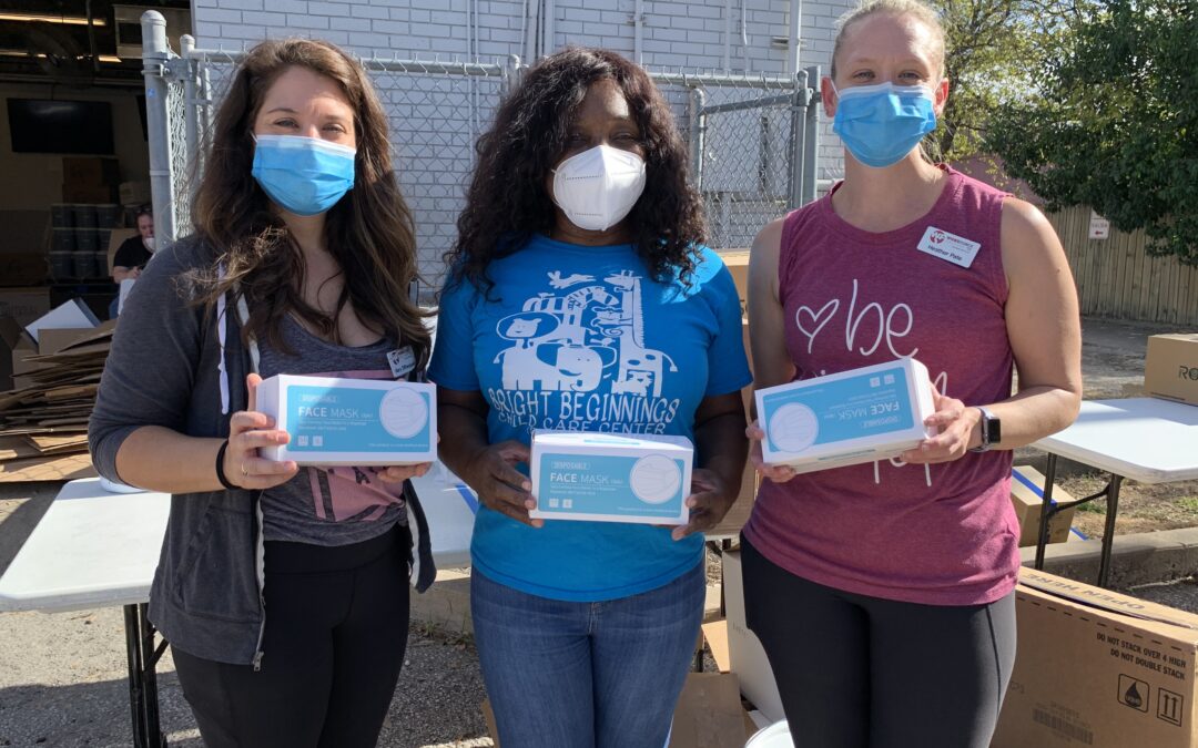 Child Care staff hold masks with a provider